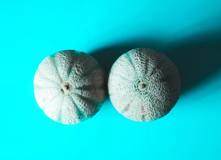 two melons on a blue surface